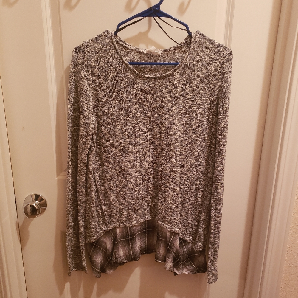 Black and grey knitted top with a plaid skirt hem